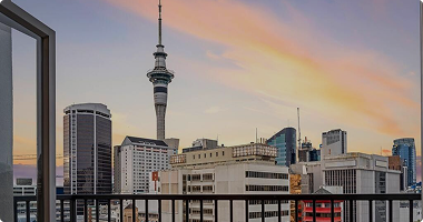 City skyline with iconic tower at sunset